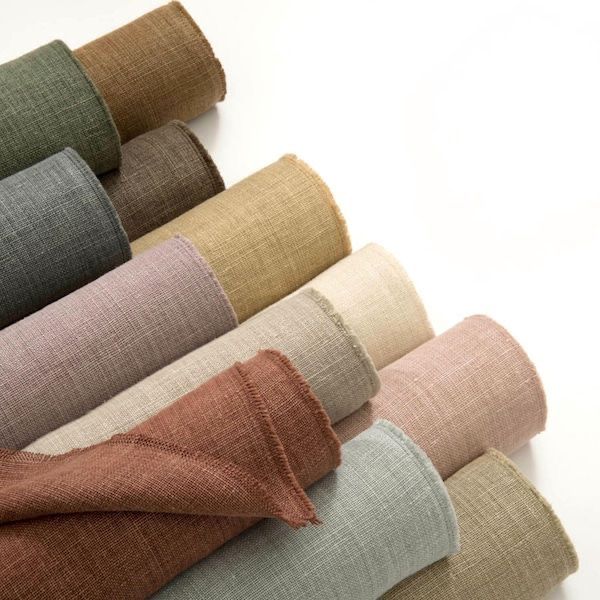 Rolls of linen fabric in earth colours